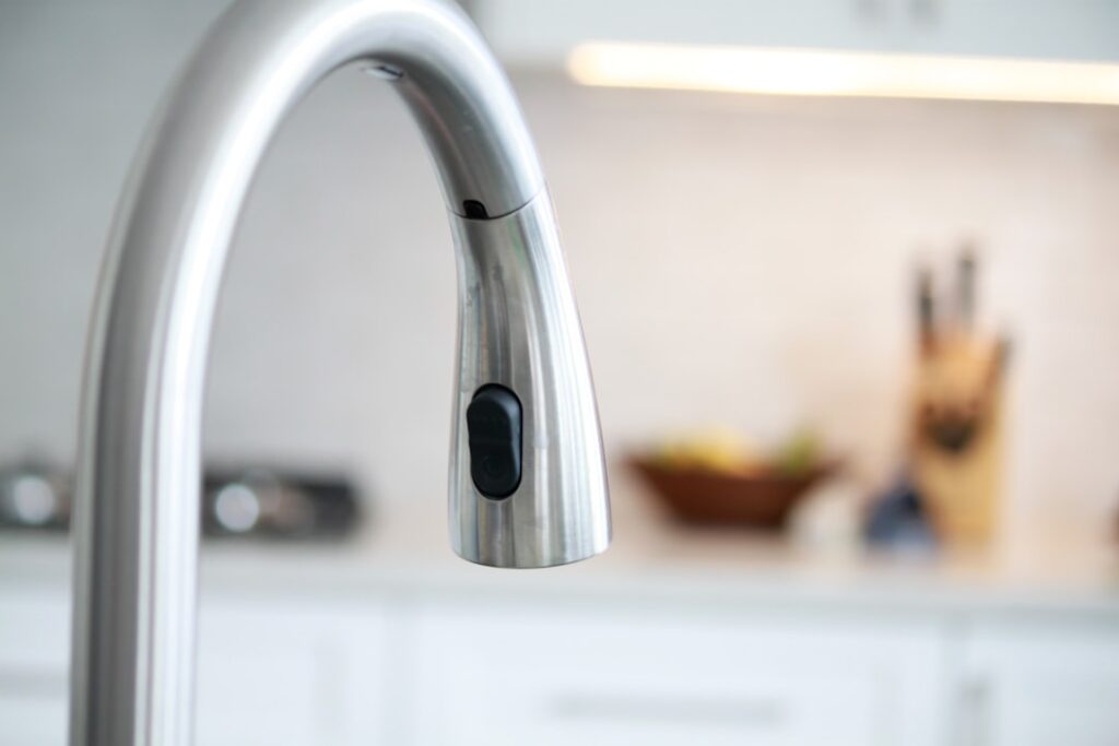 A picture of a mixing tap spout with a built in divertor, found in the kitchen