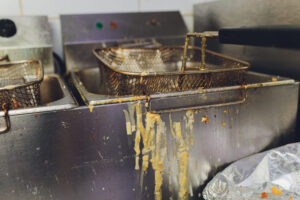 a dirty grease trap in a kitchen