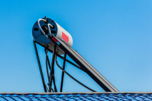 Solar water heater on the roof of a building against the background of the sky. Using solar energy to heat water in Potchefstroom