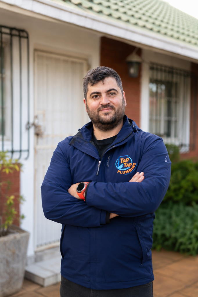Founder of Tap Tap Plumbing standing outside a residential property in Potchefstroom